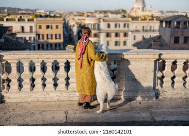 Woman Enjoys Beautiful Cityscape Of Old Rome City, Standing Back With Her Dog On The Top Of Spanish Steps In The Morning. Concept Of Italian Lifestyle And Travel