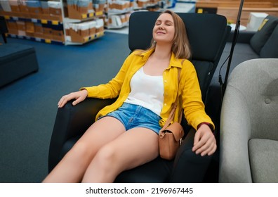 Woman Enjoys A Massage Chair In A Store.