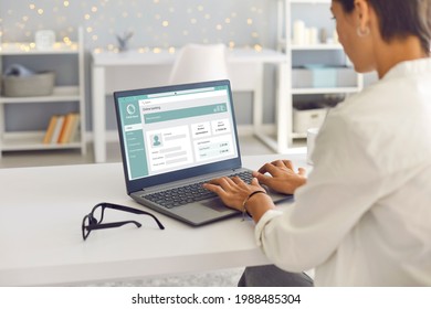 Woman Enjoys Online Banking For Work, Business Or Personal Needs. Businesswoman Or Remote Worker Sitting At Desk At Home, Using Laptop Computer, Managing Her Bank Account And Transferring Money Online