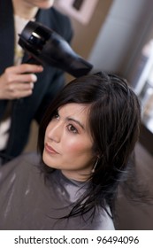 Woman Enjoys A Professional Haircut Style And Blow Dry At The Salon