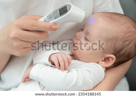 Woman ensures baby's wellness with tech. Concept of modern motherhood and health precautions
