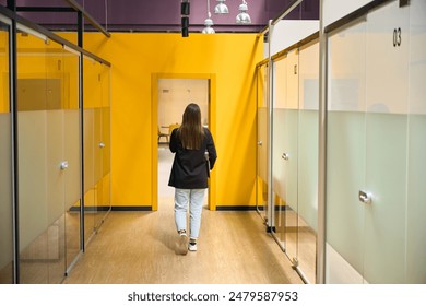 Woman enters the office from the corridor - Powered by Shutterstock