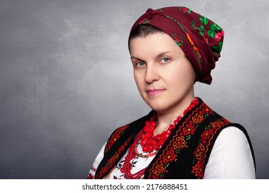 Woman in ethnic costume. Ukrainian national embroidered clothes. Close-up of a beautiful adult Caucasian woman in traditional authentic Ukrainian clothes. Ukrainian handmade vyshyvanka.
