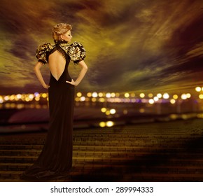 Woman Evening Dress Posing On City Night Lights, Fashion Model In Long Gown, Back Rear View Looking To Side, Urban Nightlife