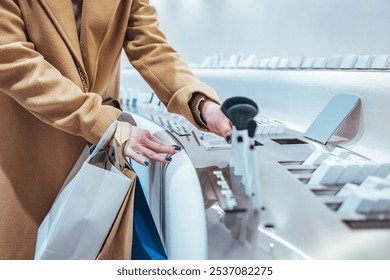 A woman examines various cosmetic products in a stylish store while holding shopping bags. The scene captures a luxurious shopping experience and modern retail environment. - Powered by Shutterstock