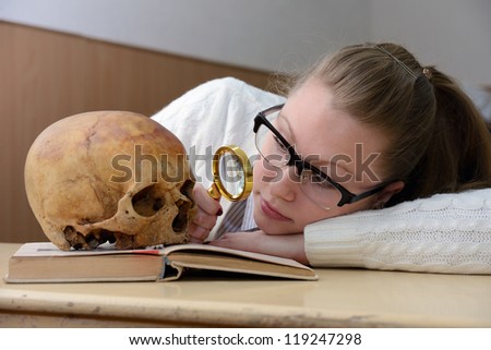 Woman examining a human skull