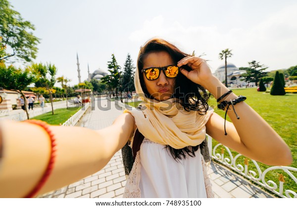 Woman\
exchange student makes selfie and face\
duck