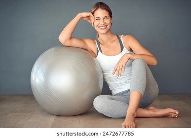 Woman, exercise ball and training for portrait, wellness and fitness with smile for motivation. Gym, performance and athlete with wall background for workout health, weight loss support and pilates - Powered by Shutterstock