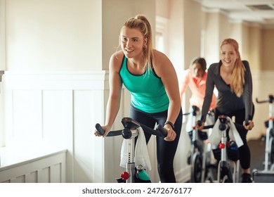 Woman, exercise bike and gym for performance, training and cycling for fitness or spin class. Female person, riding and stationary machine for workout challenge, aerobic instructor and equipment - Powered by Shutterstock