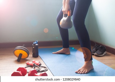 Woman Exercise With Kettlebell At Home