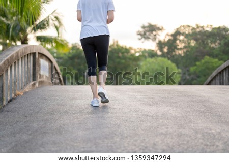 Woman exercise walking in the park in morning.