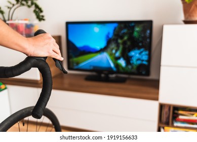 Woman Exercises Indoors Using Her Bike For A Virtual Race.