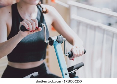 woman exercising and doing arm muscle exercises at home - Shutterstock ID 1718586250
