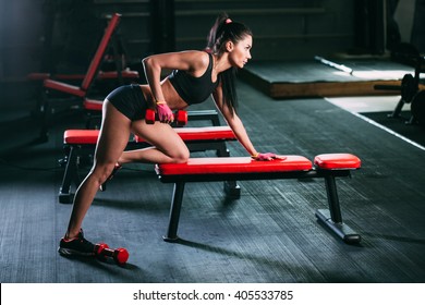 Woman Exercising Dumbbell Row At The Gym