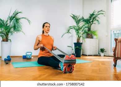 Woman Exercising with Elastic Band. Rowing Exercise Strength Training. - Powered by Shutterstock