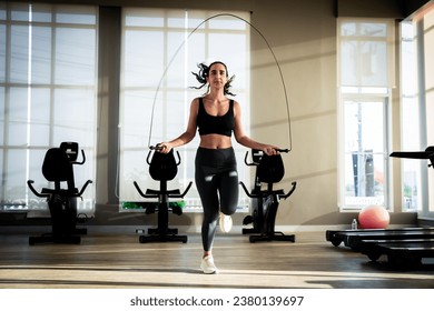 Woman exercising in the gym By jumping rope to lose weight - Powered by Shutterstock