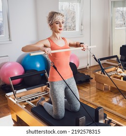 Woman Exercising On Pilates Reformer Bed Stock Photo Shutterstock