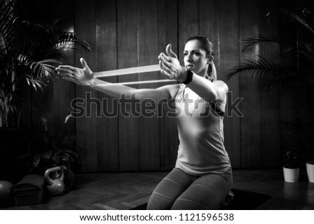 Similar – Rear view portrait of one young middle age athletic woman at crossfit training, exercising with trx suspension fitness straps over dark background