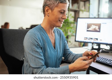 Woman experiencing neck pain while working at desk with dual monitors in office