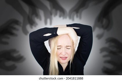 The woman is experiencing a panic attack. The concept of phobia, fears, paranoia and persecution mania. Shadow silhouettes surrounded the man. Nervous breakdown and nervous disorders