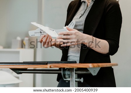 A woman explaining aerodynamics in a classroom