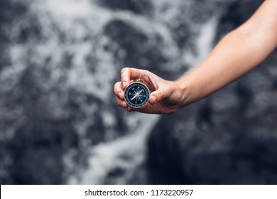 Woman Explorer Searching Direction With Compass In Waterfalls, Point Of View Shot - Shutterstock ID 1173220957