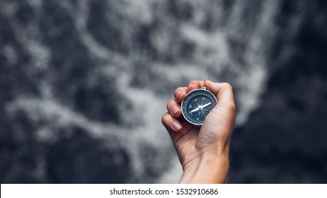 Woman Explorer Searching Direction With Compass In Waterfalls, Point Of View Shot with copy-space - Shutterstock ID 1532910686