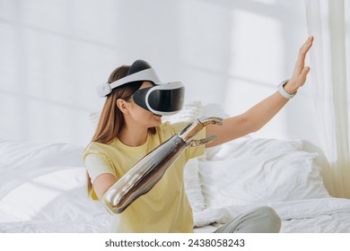 A woman explores virtual reality, wearing a VR headset and interacting with a futuristic robotic arm in a bright bedroom, symbolizing the blend of virtual experiences with advanced technology. Woman