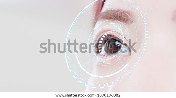 Woman eye with futuristic\
vision system - Concept of control and security in the accesses\
technology
