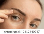  Woman with eyebrows one week after permanent makeup. 