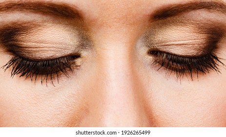 Woman face closed eyes. Girl showing eye makeup