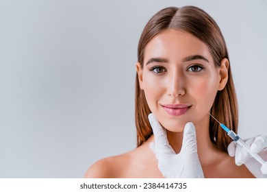 Woman face cosmetology or plastic surgery and beauty concept on background. Beautification with injections. Cosmetologist hands doing fillers with acid botox, anti-age procedure rejuvenation - Powered by Shutterstock