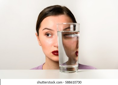 Woman Face Distortion In Glass Of Water