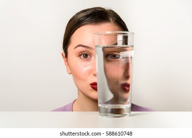 Woman Face Distortion In Glass Of Water