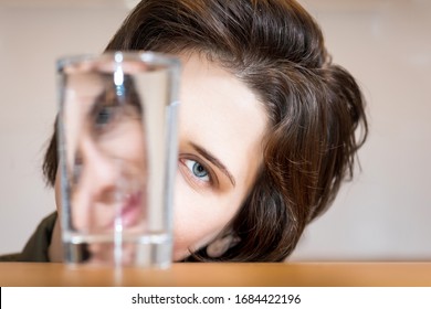 Woman Face Distortion In Vessel Of Water. Creative Refraction Photography