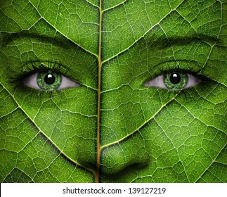 Woman Face With Leaf Texture And Green Eyes. Ecology Concept.