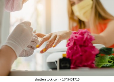 Woman With Face Mask During Manicure In Nail Salon