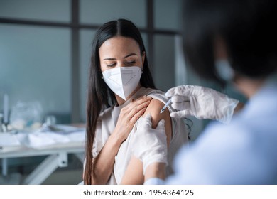 Woman with face mask getting vaccinated in hospital, coronavirus and vaccination concept. - Powered by Shutterstock