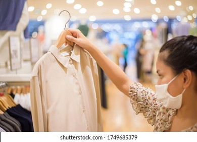 Woman With Face Mask Is Shopping Clothes In Shopping Center 