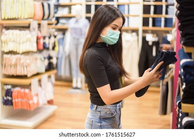 Woman With Face Mask Is Shopping Clothes In Shopping Center 