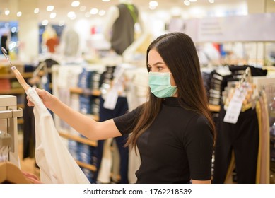 Woman With Face Mask Is Shopping Clothes In Shopping Center 