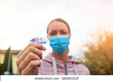 Woman With Face Mask Showing I Voted Sticker At American Elections Outside.