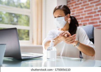 Woman In Face Mask Using  Alcohol Handwash Hygiene Gel