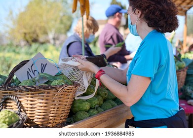 Woman With Face Masks Buying Fresh Vegetables At Farmers Markets