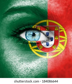 Woman face painted with flag of Portugal - Shutterstock ID 184086644