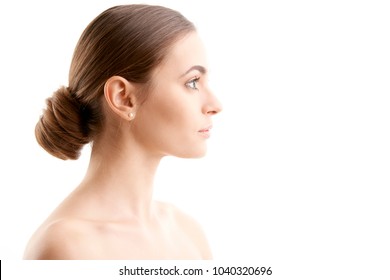 Woman Face Profile Shot. Beautiful Young Woman With Perfect Skin Looking Away While Standing At Isolated White Background. 