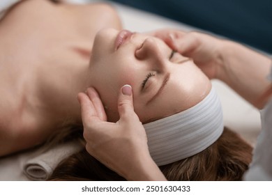 Woman with facial mask. Cosmetic procedure. Beauty spa and cosmetology. Beauty treatments. Facial lifting in SPA salon. Cosmetologist girl does facial massage. Cosmetic procedure. Beauty cosmetology. - Powered by Shutterstock