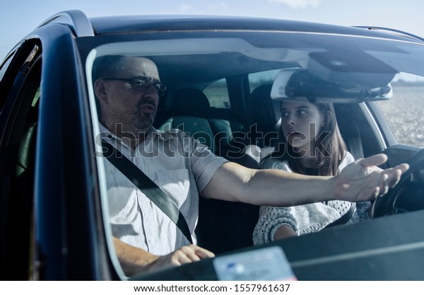 Woman failed on driving test. Driving school. Sad\
and disappointed teenager failed on driving test. Student driver\
taking driving class