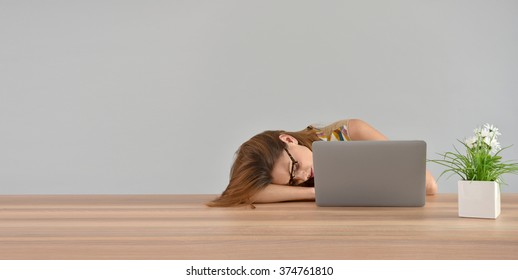 Woman falling asleep in front of laptop