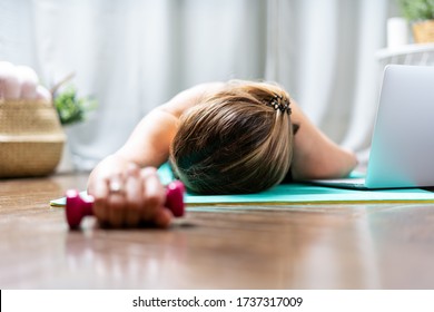 Woman Falling Asleep. Tired After Exercise And Workout. Overtraining Concept. Exhausted Woman Lying On Floor And Resting After Heavy Cardio Training In Home Gym At Yoga Mat.